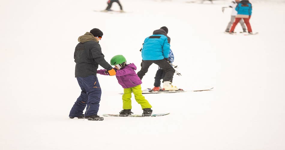 Snowboarding child learning.