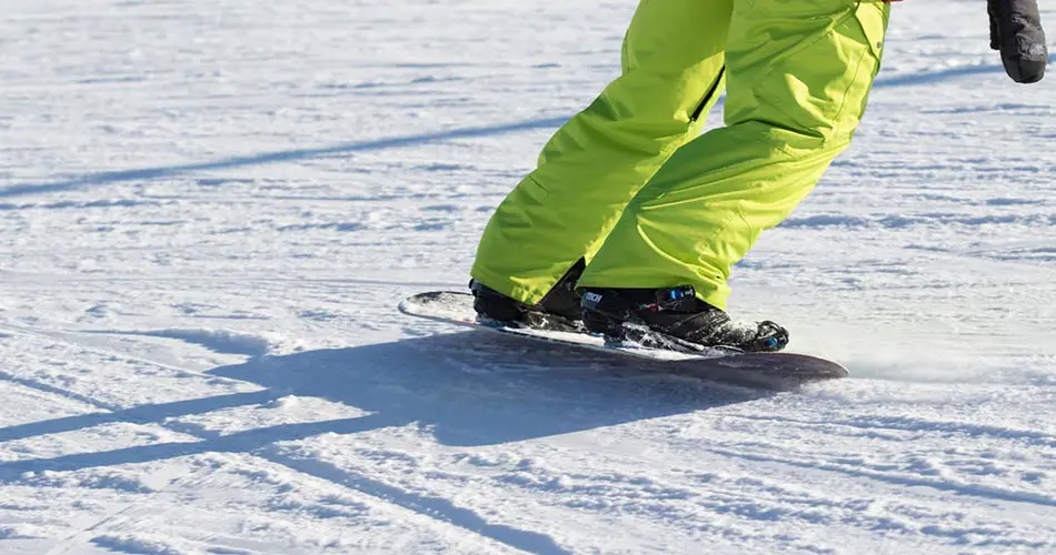 Snowboarder on trail at Sugarloaf, Maine.