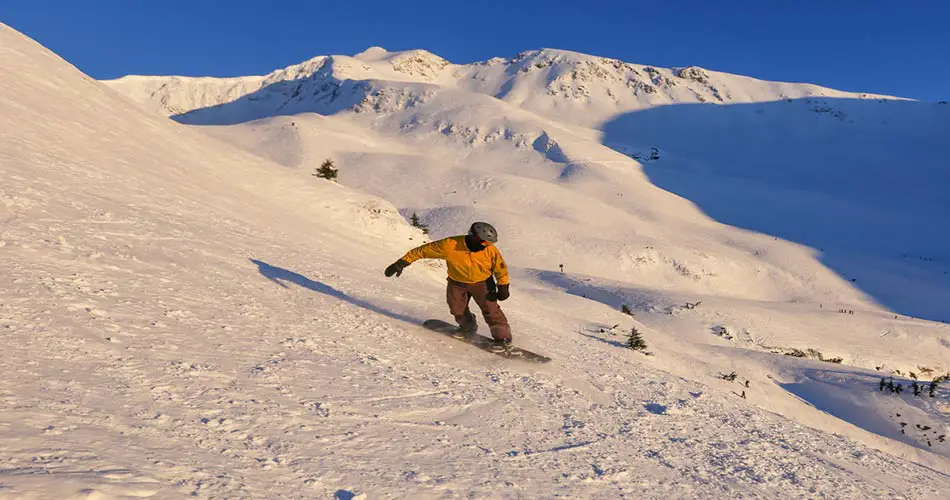 Snowboarder on trails at Alyeska.