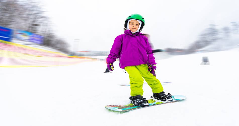 Child snowboarding at Mohawk Mountain Ski Area.