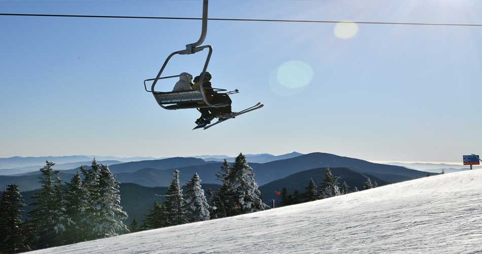 Riding ski lifts at Stowe Mountain Resort.