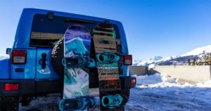 Snowboards leaning on jeep.
