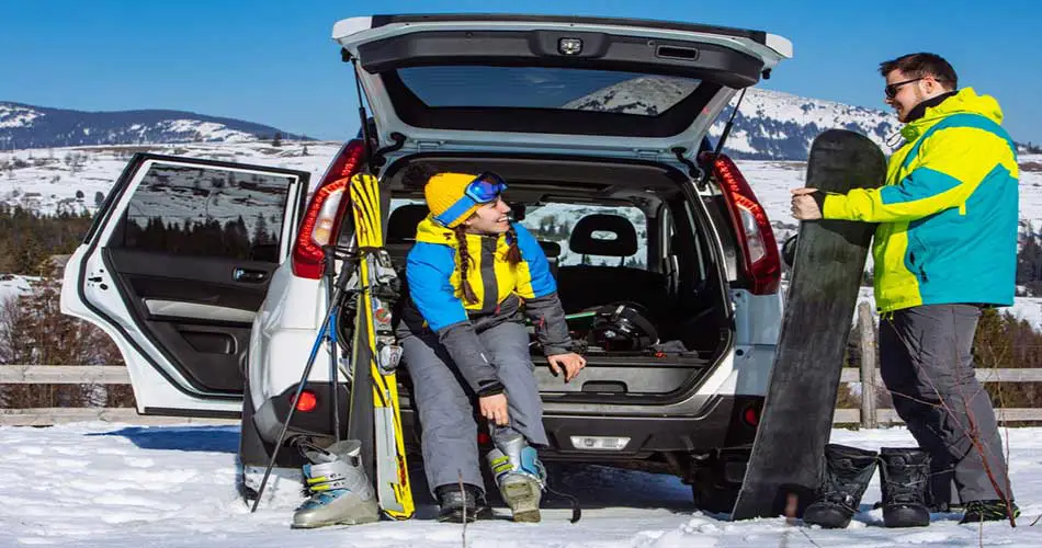 Skier getting ready at car