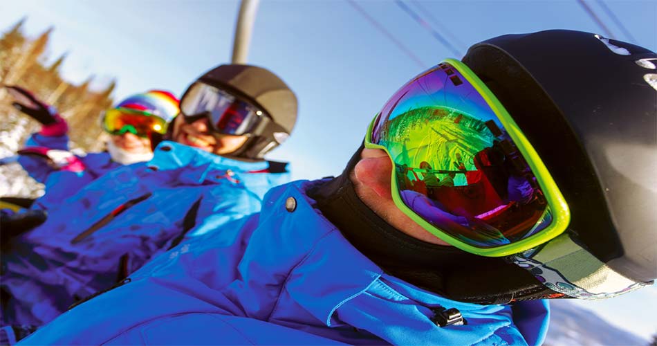 Beginner skiers wearing helmets