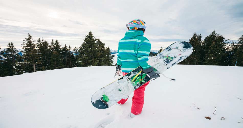 Standing with snowboard