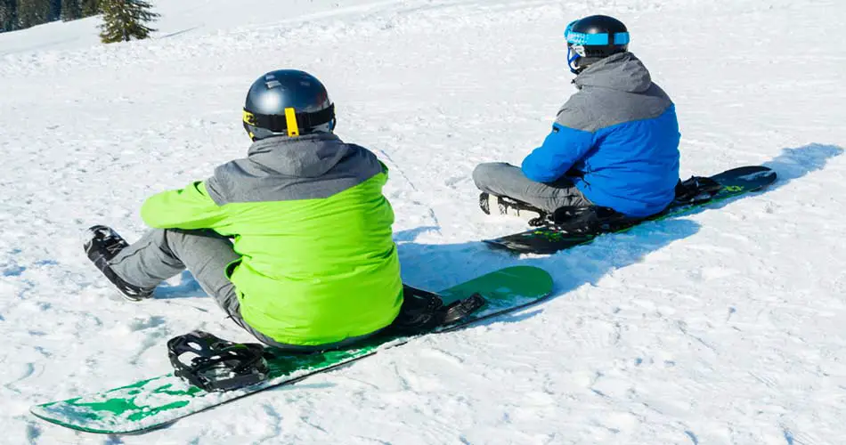 Snowboard instructor with student.