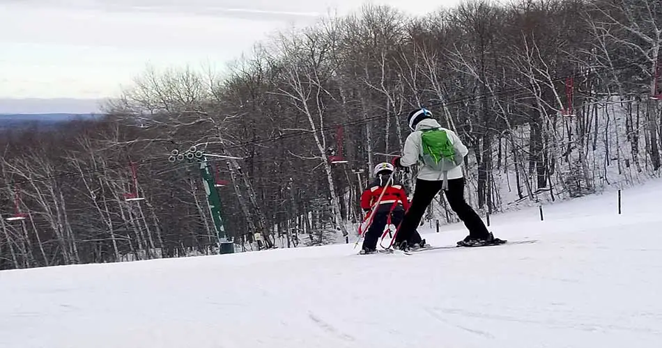 Skiing with a child ski harness.