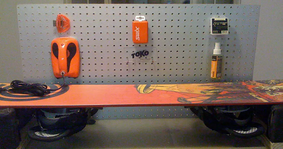 Snowboarding waxing set up on work bench.