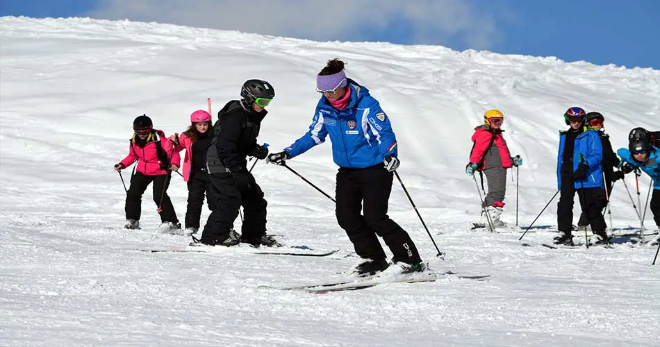 Ski instructor teaching group lessons