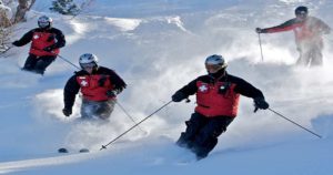 Ski patrol riding on slopes