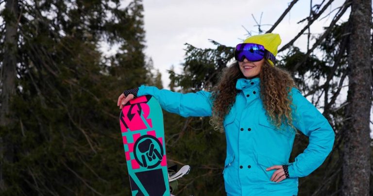 Woman snowboarder with board