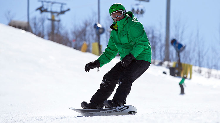 Snowboarder shredding the slopes.