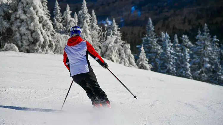 intermediate skier on trails