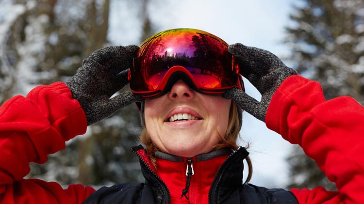 skier adjusting goggles