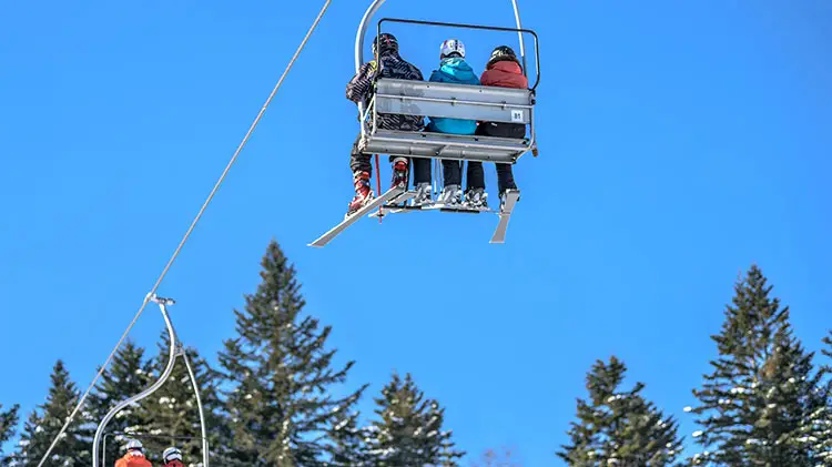 skiers on ski lifts