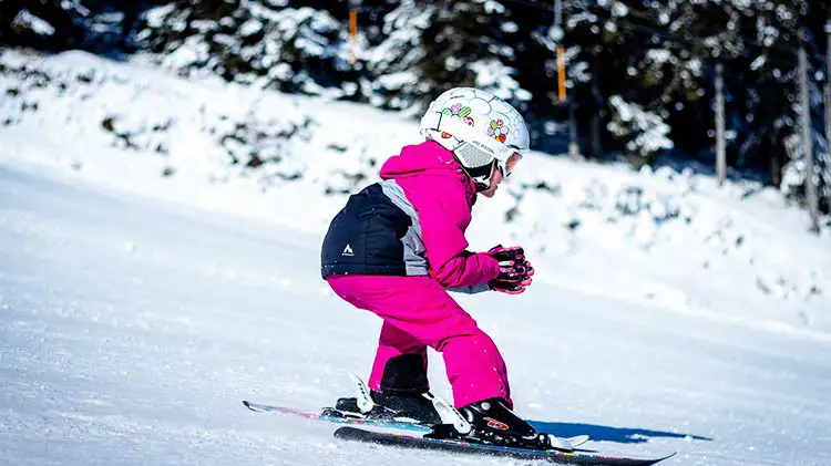 skiing child in pink