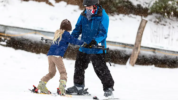 Wolf Ridge learning to ski girl with instructor